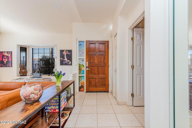 foyer entrance with light tile patterned floors