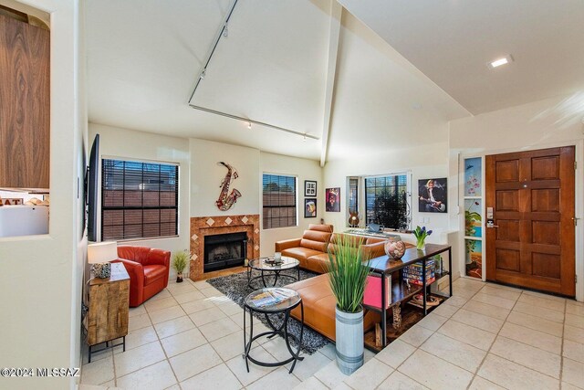 tiled living room featuring a tiled fireplace and rail lighting