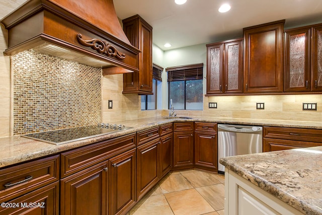 kitchen featuring stainless steel dishwasher, sink, black electric stovetop, and decorative backsplash