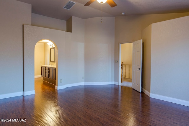 spare room featuring vaulted ceiling, dark hardwood / wood-style floors, and ceiling fan