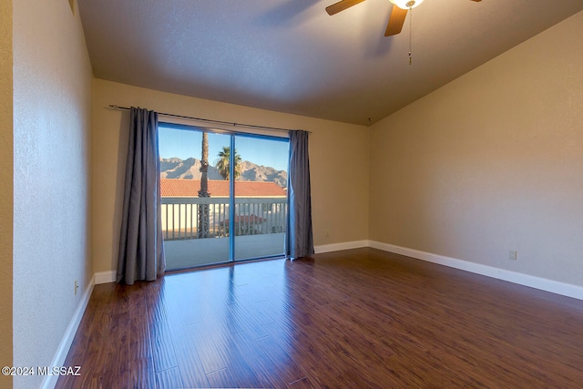 unfurnished room featuring ceiling fan, vaulted ceiling, and dark hardwood / wood-style flooring