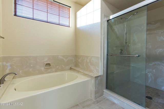 bathroom with tile patterned floors and shower with separate bathtub