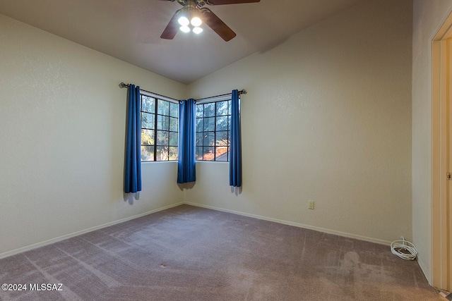 carpeted spare room with ceiling fan and lofted ceiling