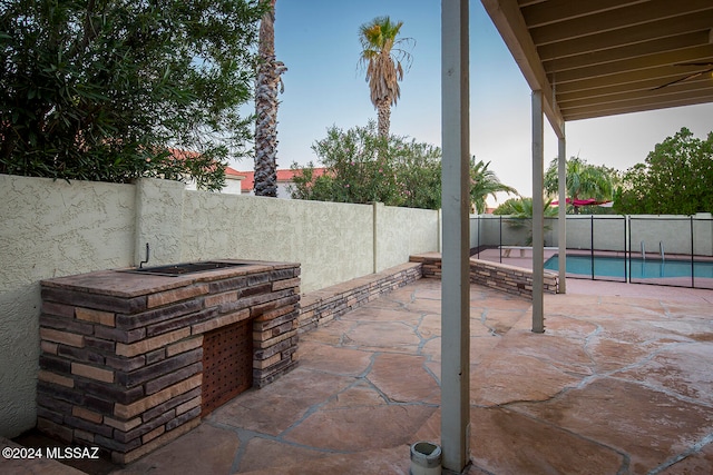 view of patio featuring a fenced in pool