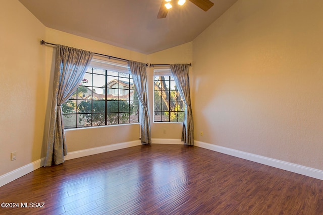 unfurnished room with ceiling fan, vaulted ceiling, and dark hardwood / wood-style floors