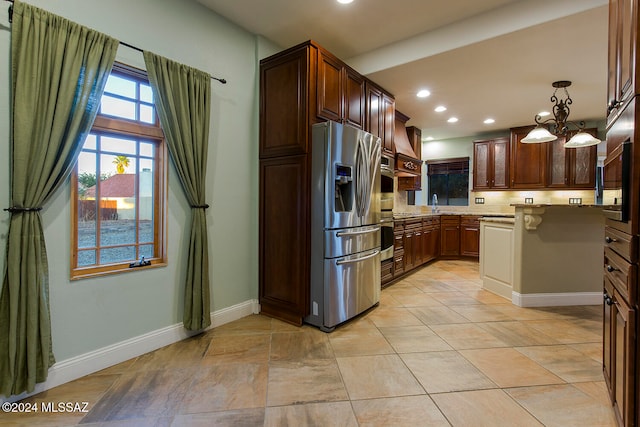 kitchen featuring stainless steel refrigerator with ice dispenser, a chandelier, and pendant lighting