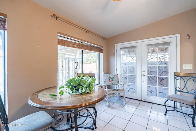 sunroom / solarium featuring vaulted ceiling and french doors