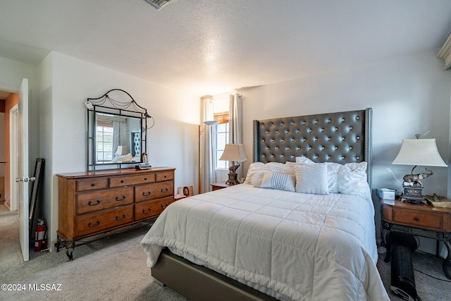 carpeted bedroom featuring a textured ceiling