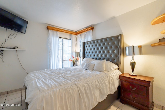 bedroom with light tile patterned floors