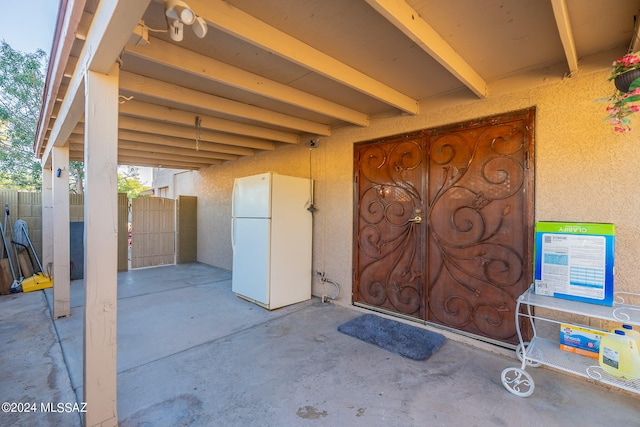 view of exterior entry with a patio