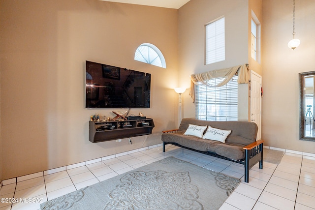 living room with a high ceiling and light tile patterned floors