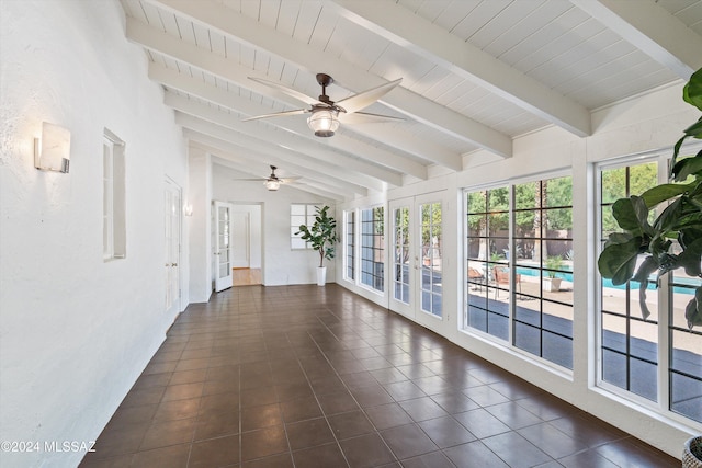 unfurnished sunroom featuring lofted ceiling with beams