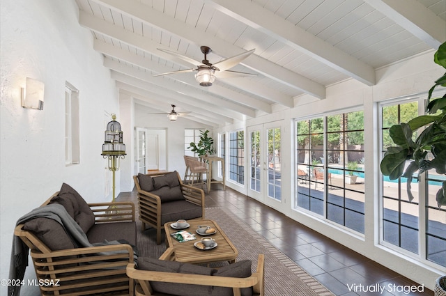 sunroom / solarium featuring vaulted ceiling with beams