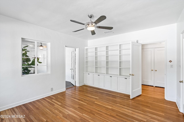 unfurnished bedroom with hardwood / wood-style floors and ceiling fan