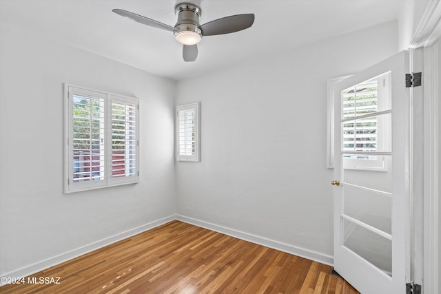 empty room with wood-type flooring and ceiling fan