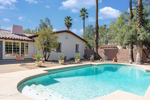 view of swimming pool with a patio