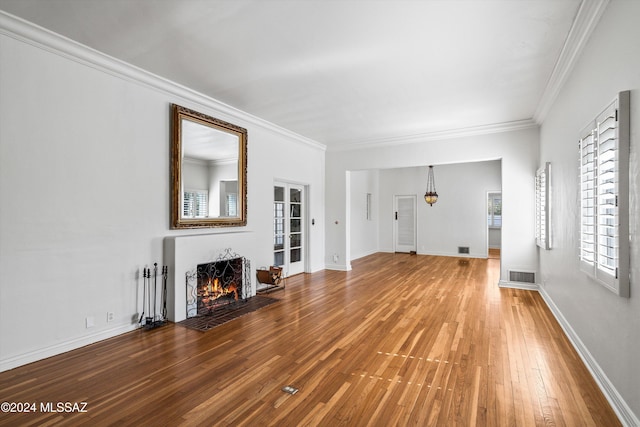 unfurnished living room with hardwood / wood-style flooring and ornamental molding