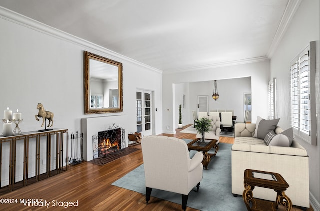 living room featuring dark hardwood / wood-style flooring and ornamental molding