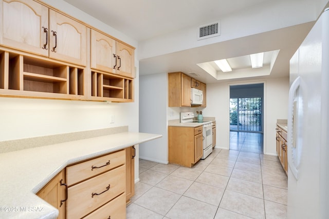 kitchen featuring white appliances, visible vents, a raised ceiling, and light brown cabinetry