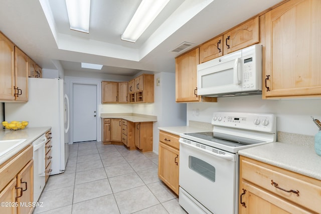 kitchen featuring white appliances, light brown cabinets, visible vents, and light countertops