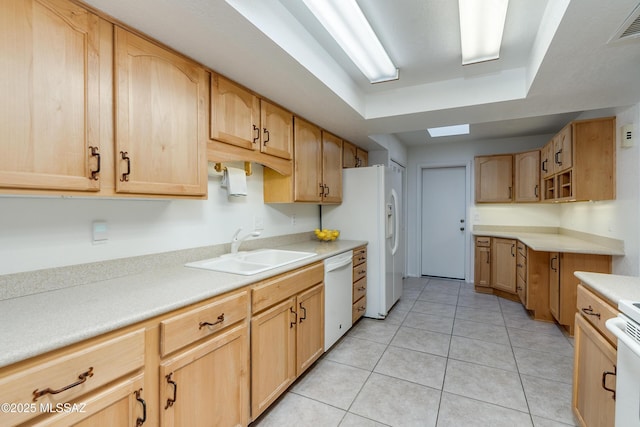 kitchen with white appliances, a sink, visible vents, light countertops, and light brown cabinetry