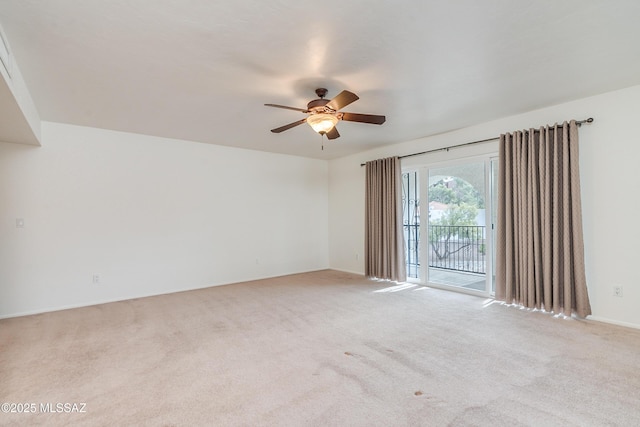 carpeted spare room with ceiling fan