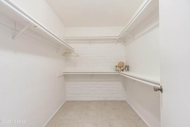 walk in closet featuring light tile patterned floors