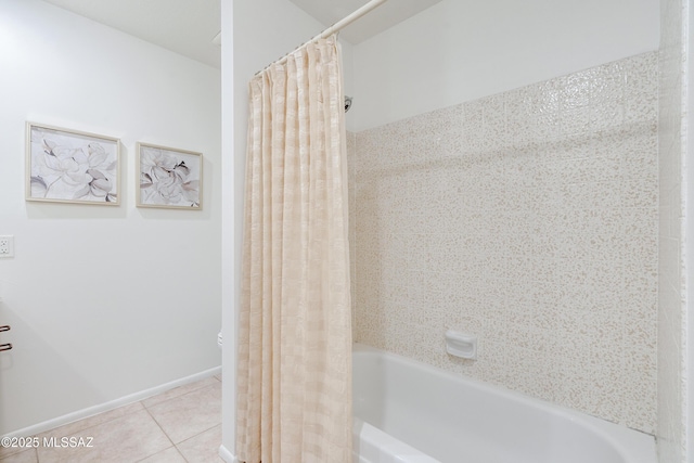 full bath featuring shower / tub combo with curtain, baseboards, and tile patterned floors