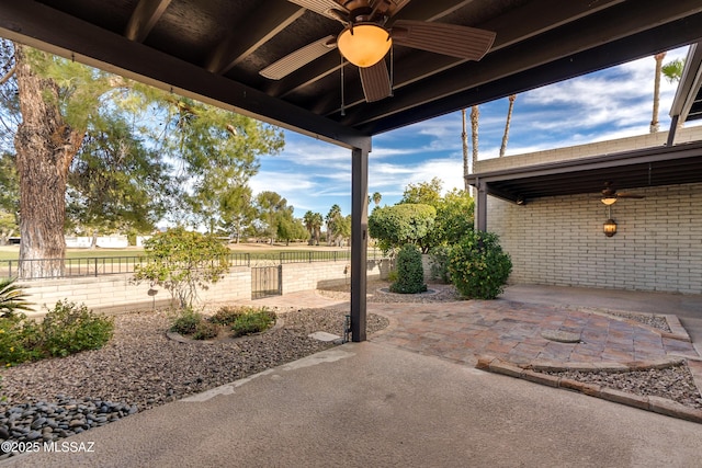 view of patio / terrace featuring a ceiling fan and fence