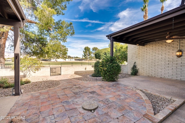 view of patio with a gate and fence