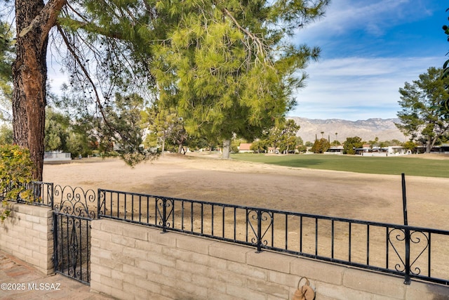 view of property's community featuring a gate, fence, and a mountain view