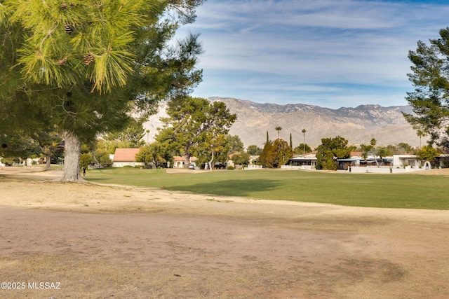 view of home's community with a mountain view and a lawn