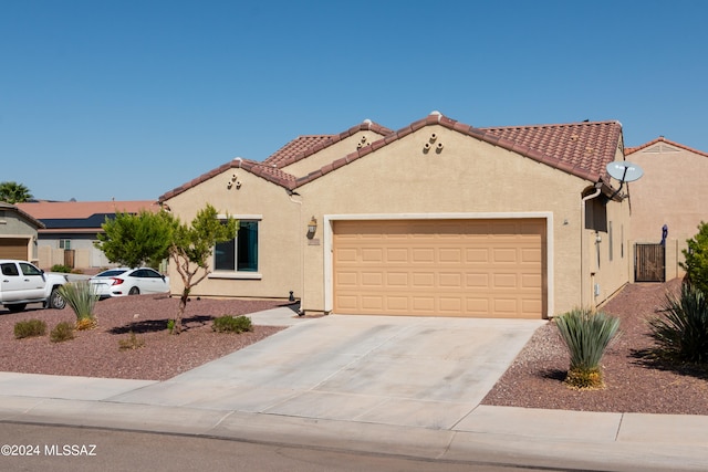 mediterranean / spanish-style home with a garage