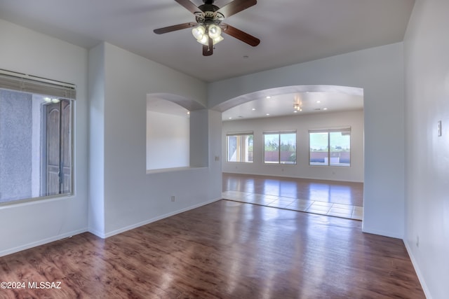 empty room featuring hardwood / wood-style floors and ceiling fan