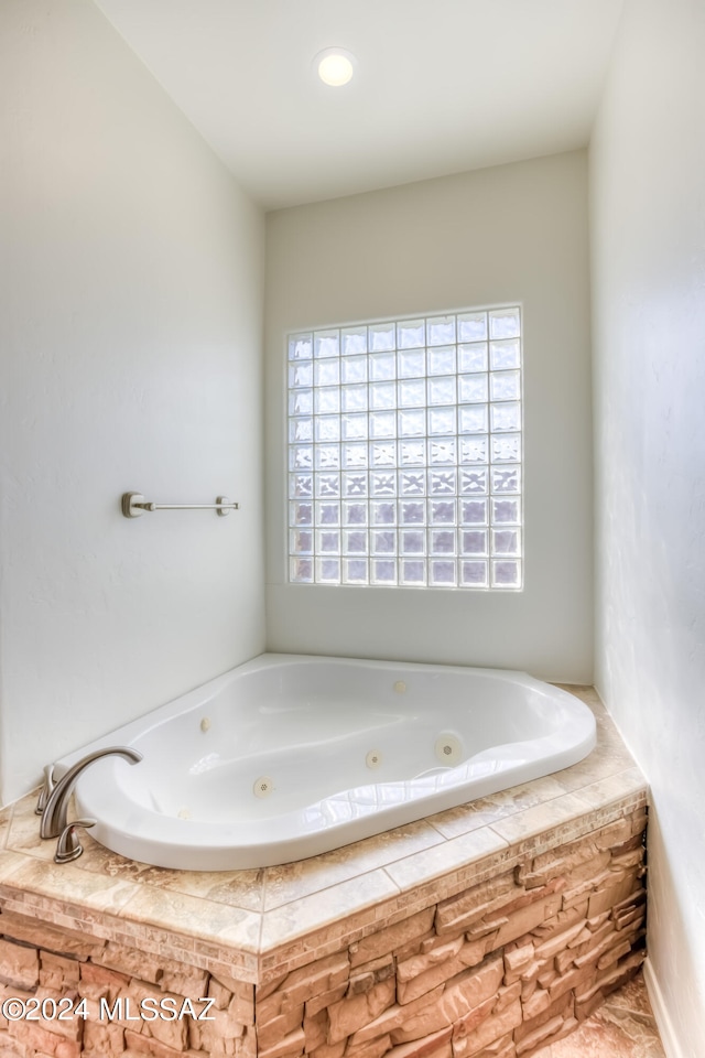 bathroom with tiled bath