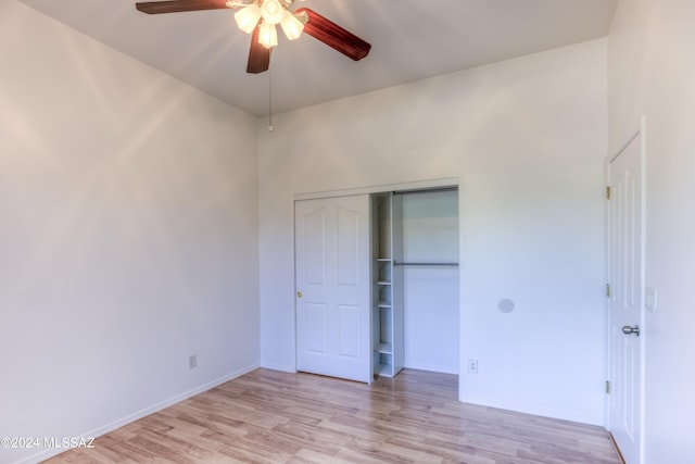 unfurnished bedroom with light hardwood / wood-style flooring, a closet, and ceiling fan