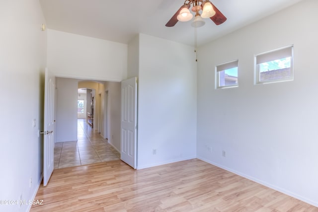 spare room with light wood-type flooring and ceiling fan