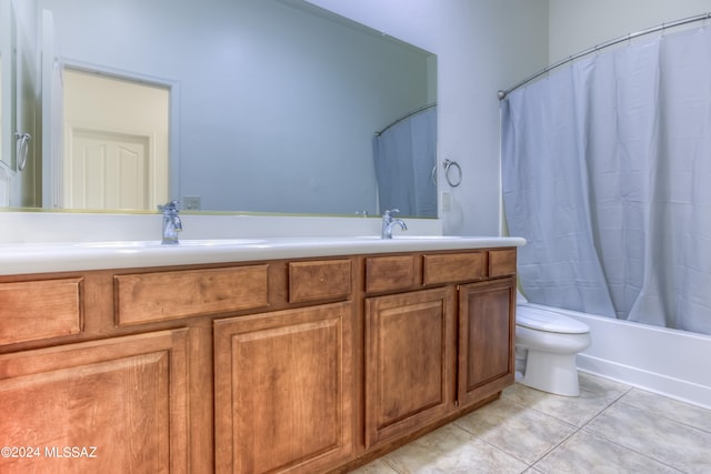 full bathroom featuring vanity, shower / bath combo with shower curtain, toilet, and tile patterned flooring