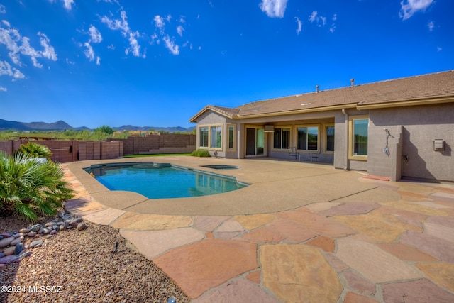 view of swimming pool with a patio area and a mountain view