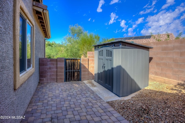 view of patio / terrace featuring a storage shed