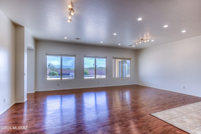 spare room featuring light hardwood / wood-style floors and track lighting