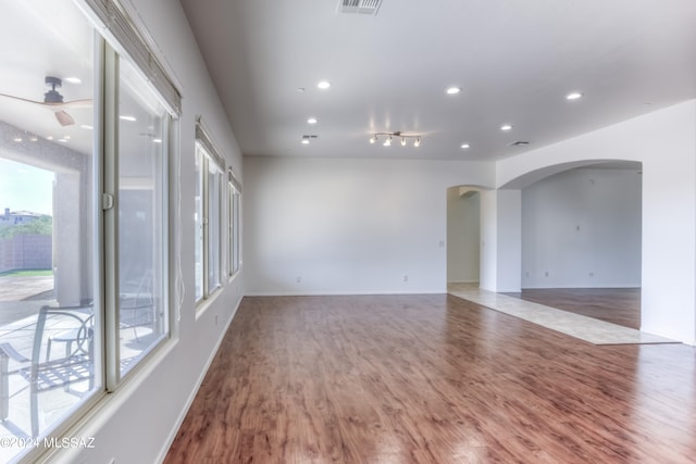 spare room featuring ceiling fan and hardwood / wood-style floors