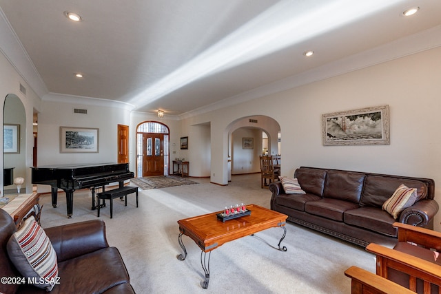 carpeted living room featuring ornamental molding