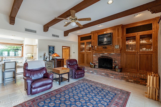 living room with light tile patterned flooring, beam ceiling, a fireplace, and ceiling fan