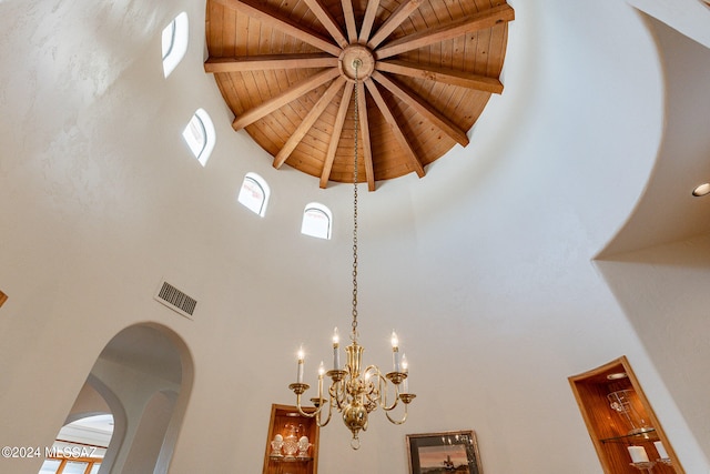 interior details featuring wooden ceiling, beam ceiling, and an inviting chandelier