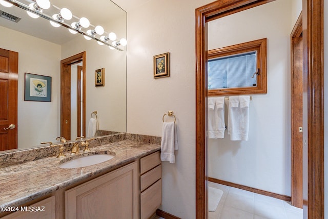 bathroom with tile patterned floors and vanity