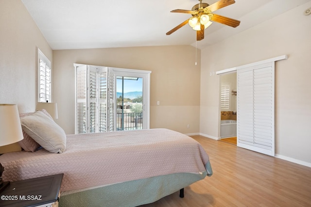 bedroom with access to exterior, light hardwood / wood-style flooring, ceiling fan, and vaulted ceiling