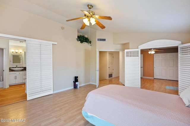 bedroom with vaulted ceiling, sink, ceiling fan, and light hardwood / wood-style floors