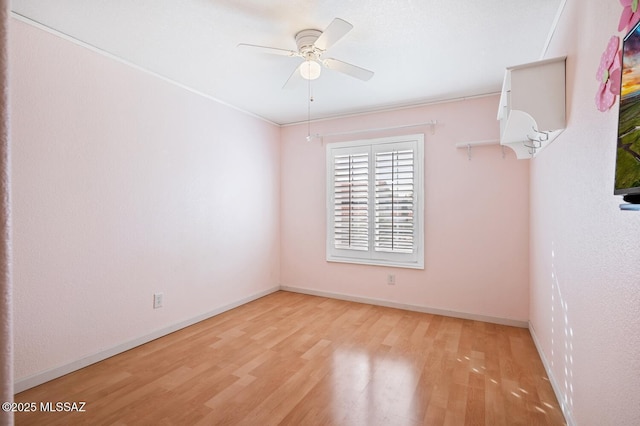 spare room featuring light hardwood / wood-style floors and ceiling fan