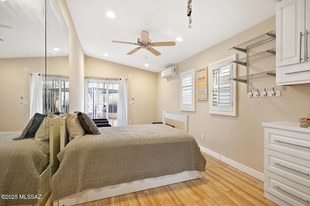 bedroom featuring lofted ceiling, light hardwood / wood-style floors, and a wall unit AC